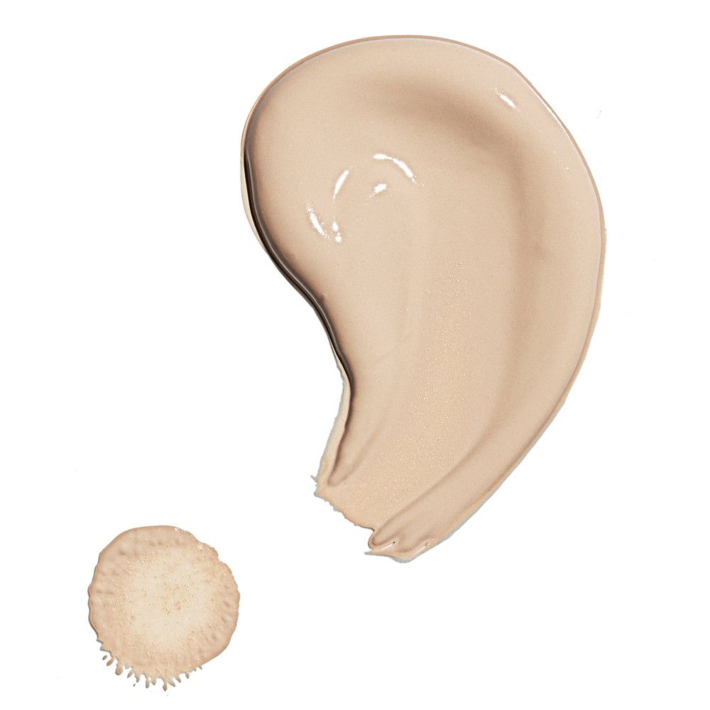 Deux éclaboussures de liquide beige. Une goutte et une trace incurvée.