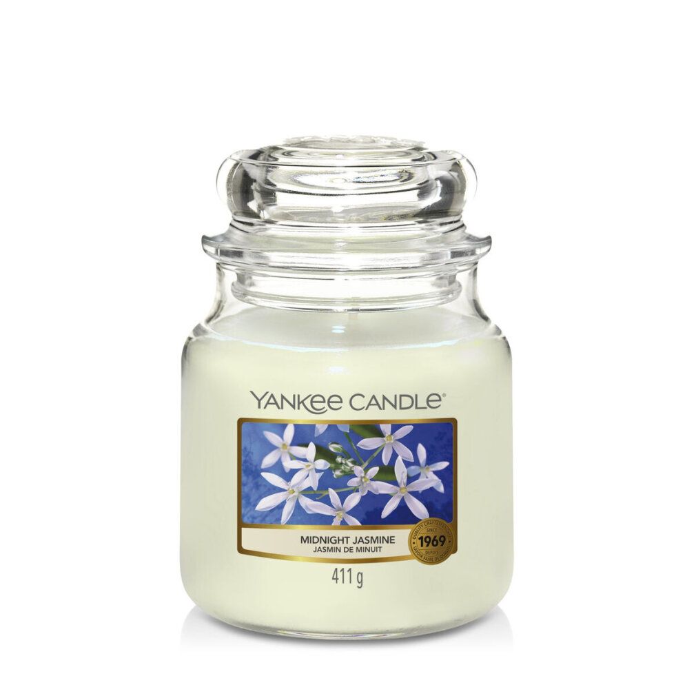 Yankee Candle Midnight Jasmine geurkaars. Glazen pot met deksel. Blauw etiket met bloemen. Gewicht: 411g.
