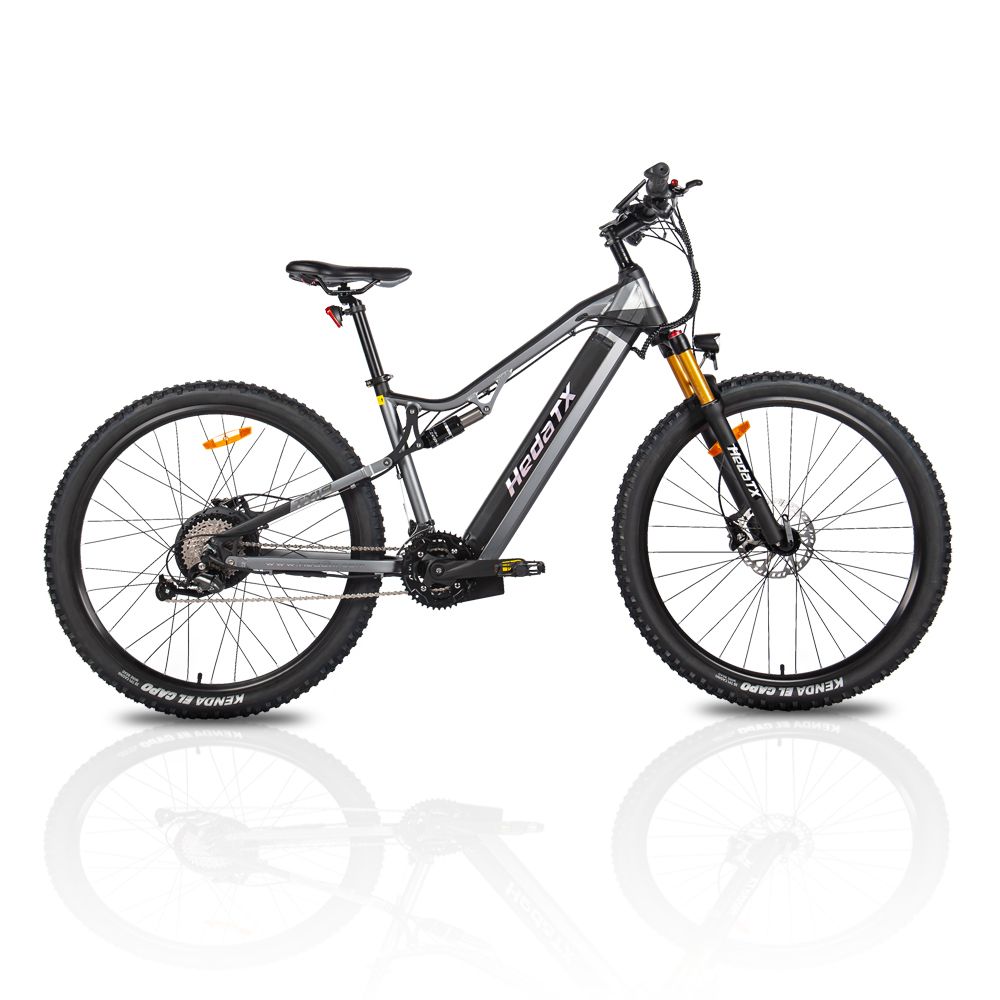 VTT électrique HedaTX TX19. Cadre noir et gris, pneus noirs. Éléments de suspension jaunes. Vue latérale, fond blanc.