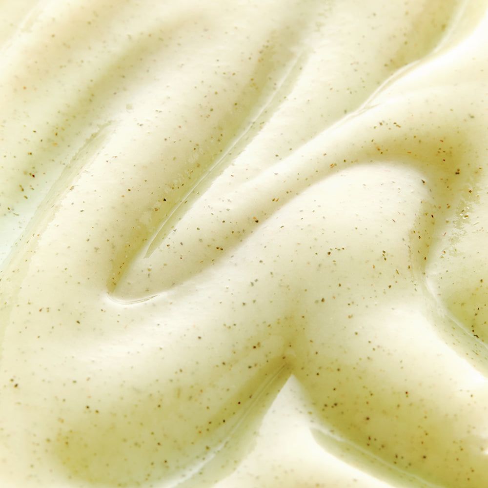 Close-up van gel. Crèmekleurige textuur met kleine donkere deeltjes.