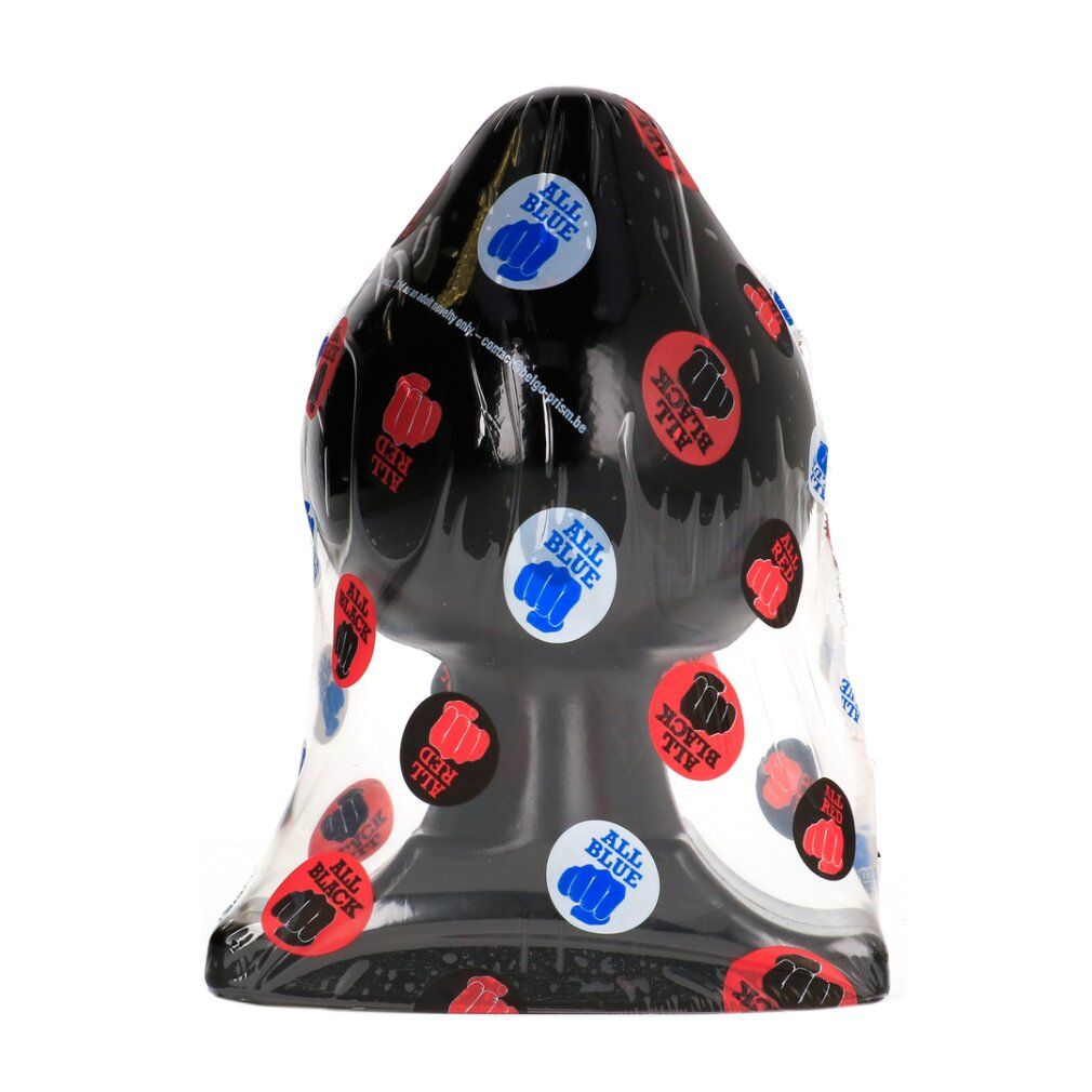 Butt plug noir dans son emballage transparent avec des autocollants ronds.