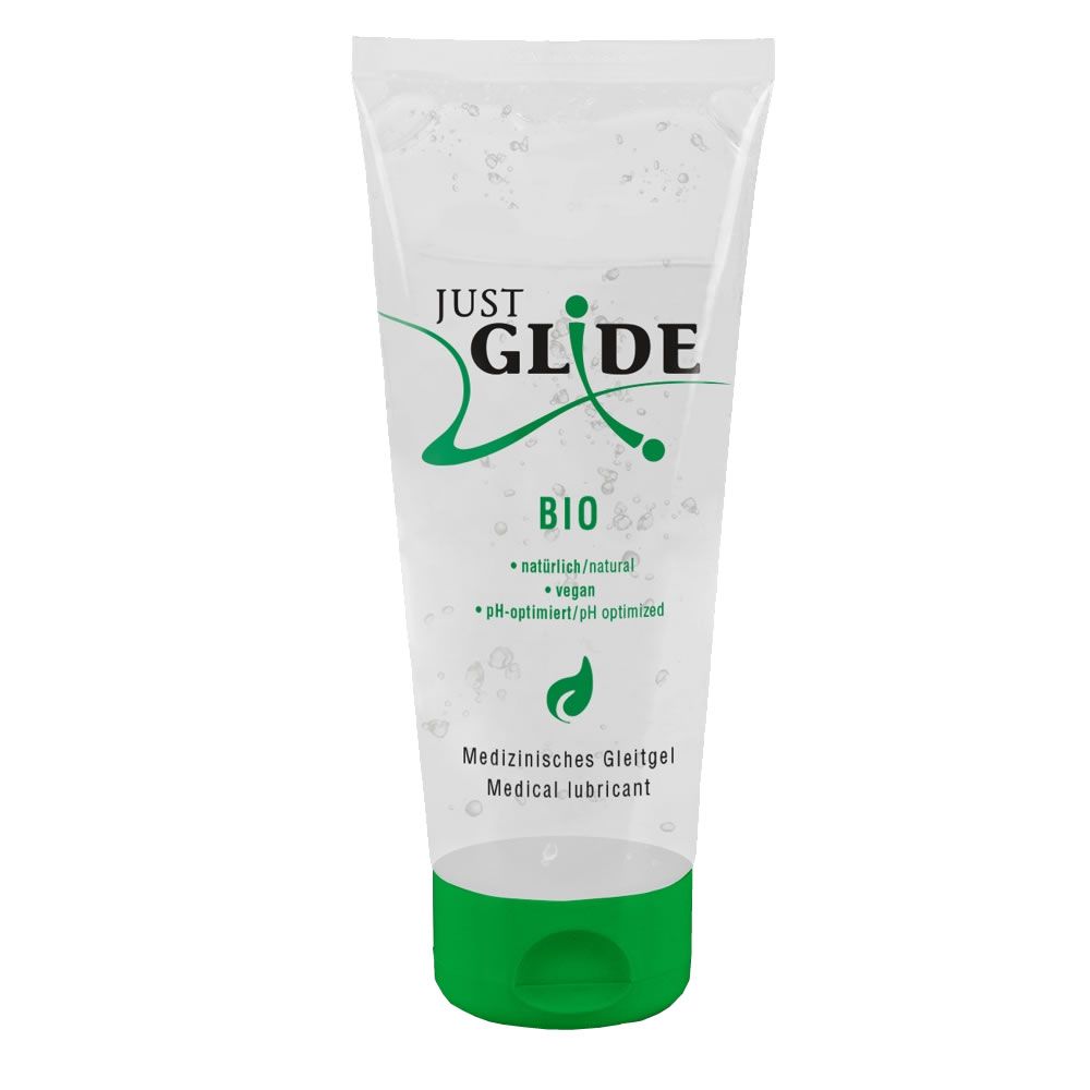 Tube transparent avec bouchon vert. Texte: JUST GLIDE BIO, vegan, pH optimisé, Lubrifiant médical.