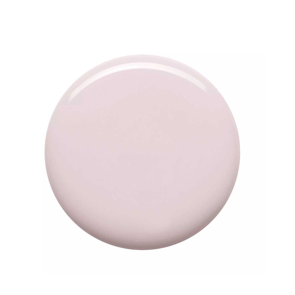 Tache circulaire de vernis à ongles rose clair. Surface brillante.