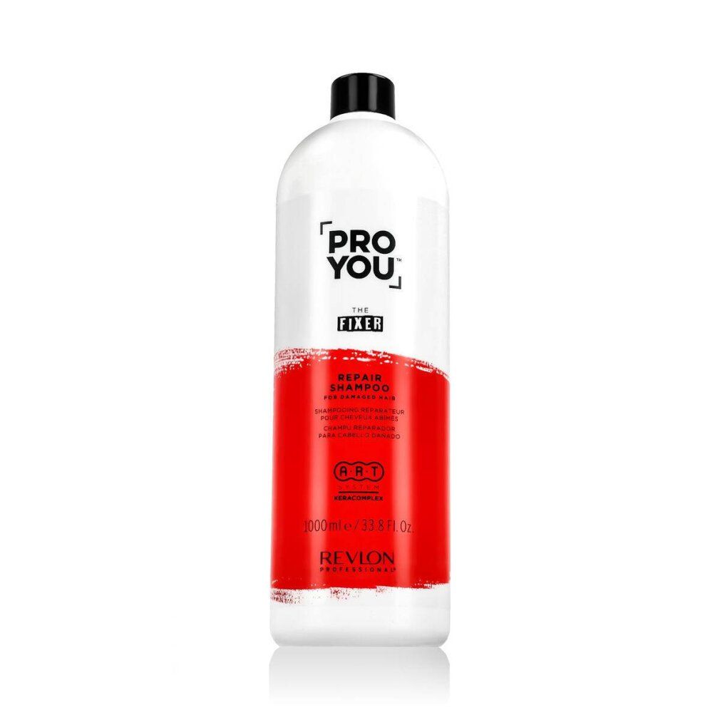 Witte fles met zwarte dop. Opschrift: Pro You The Fixer Repair Shampoo. Rode kleurvlak. Revlon Professional.