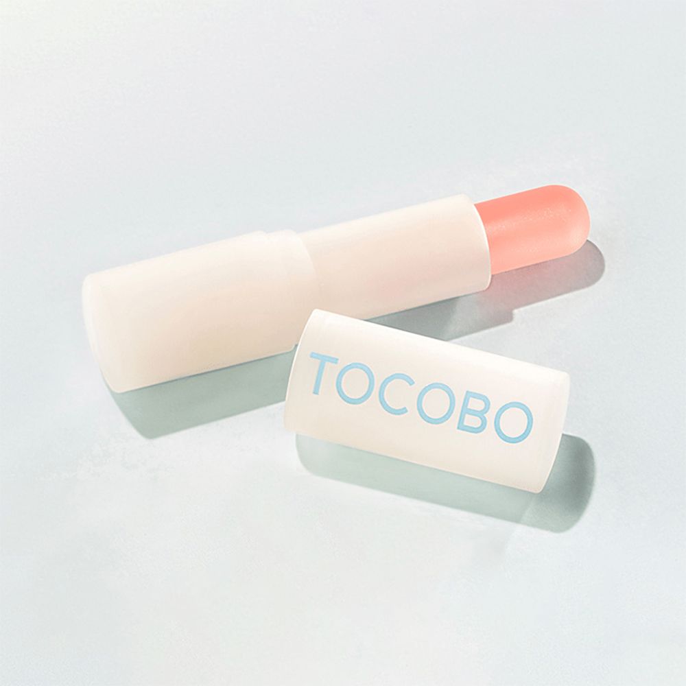 Lippenbalsem met open dop. Dop met blauwe TOCOBO tekst.