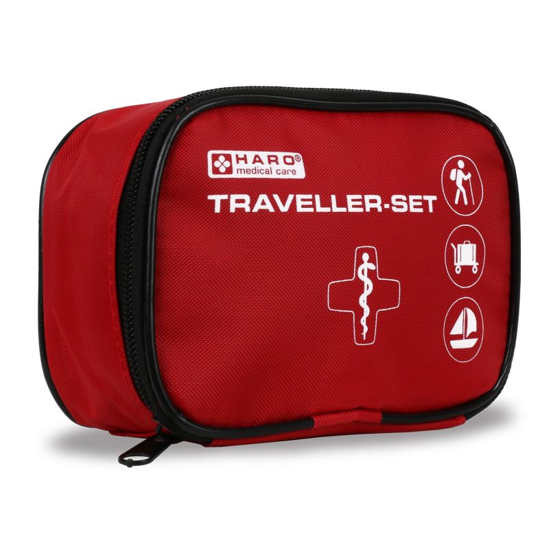 Rode EHBO-tas met zwarte rits. Opschrift: HARO medical care, TRAVELLER-SET. Symbolen: wandelaar, koffer, zeilboot.