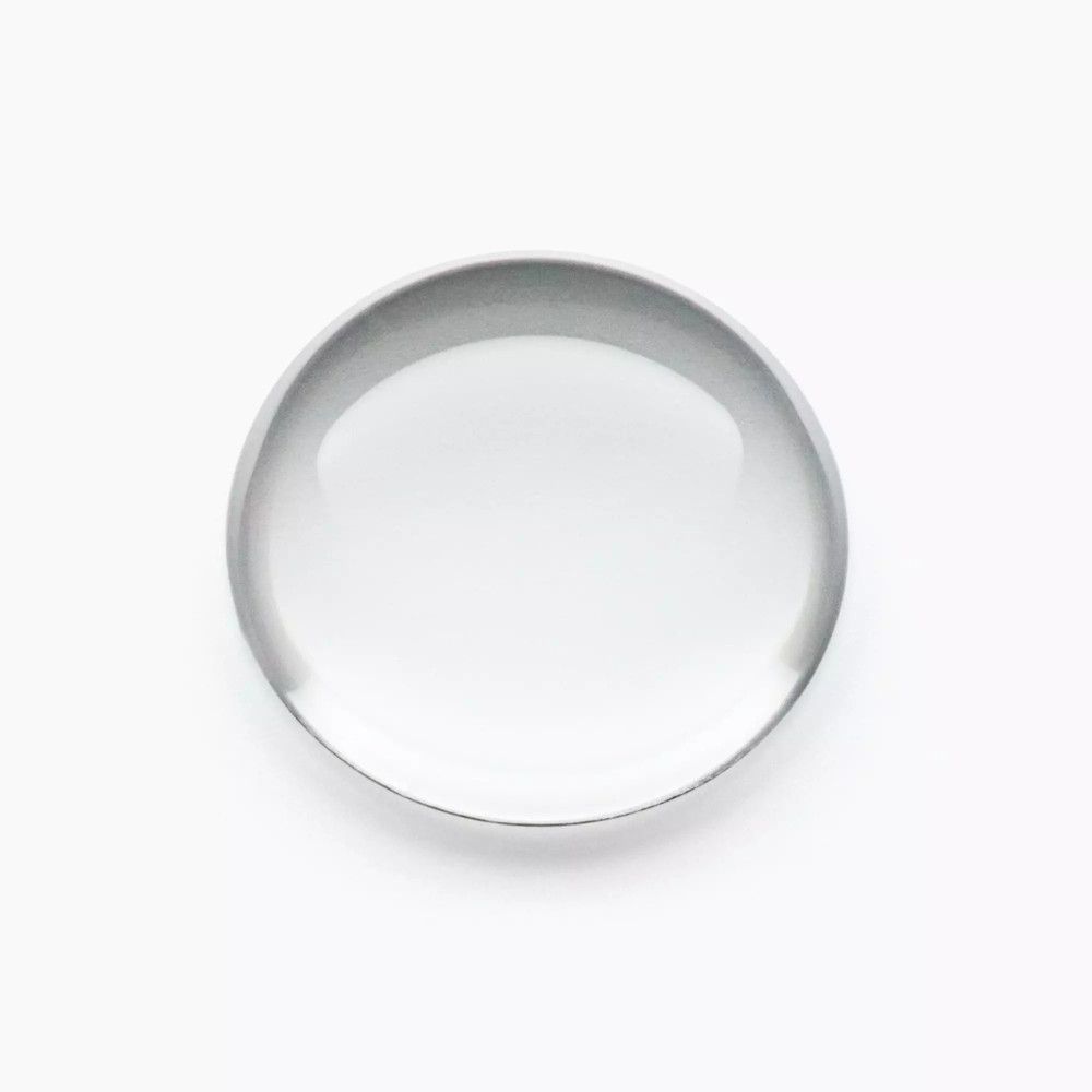 Ronde, transparante glazen plaat, vermoedelijk een lens of een vergrootglas.