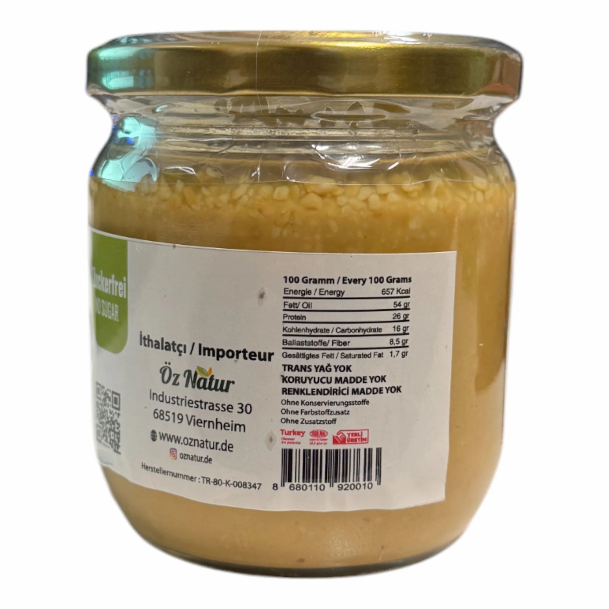 Pot de beurre de cacahuète avec étiquette. Contient des informations nutritionnelles et du texte turc. Marque : Öz Natur. Adresse de l'importateur.