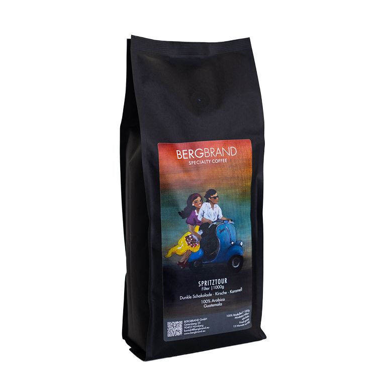 Zwarte zak met BERGBRAND-logo en illustratie. Tekst: Spritztour, Specialty Coffee, 1000g.