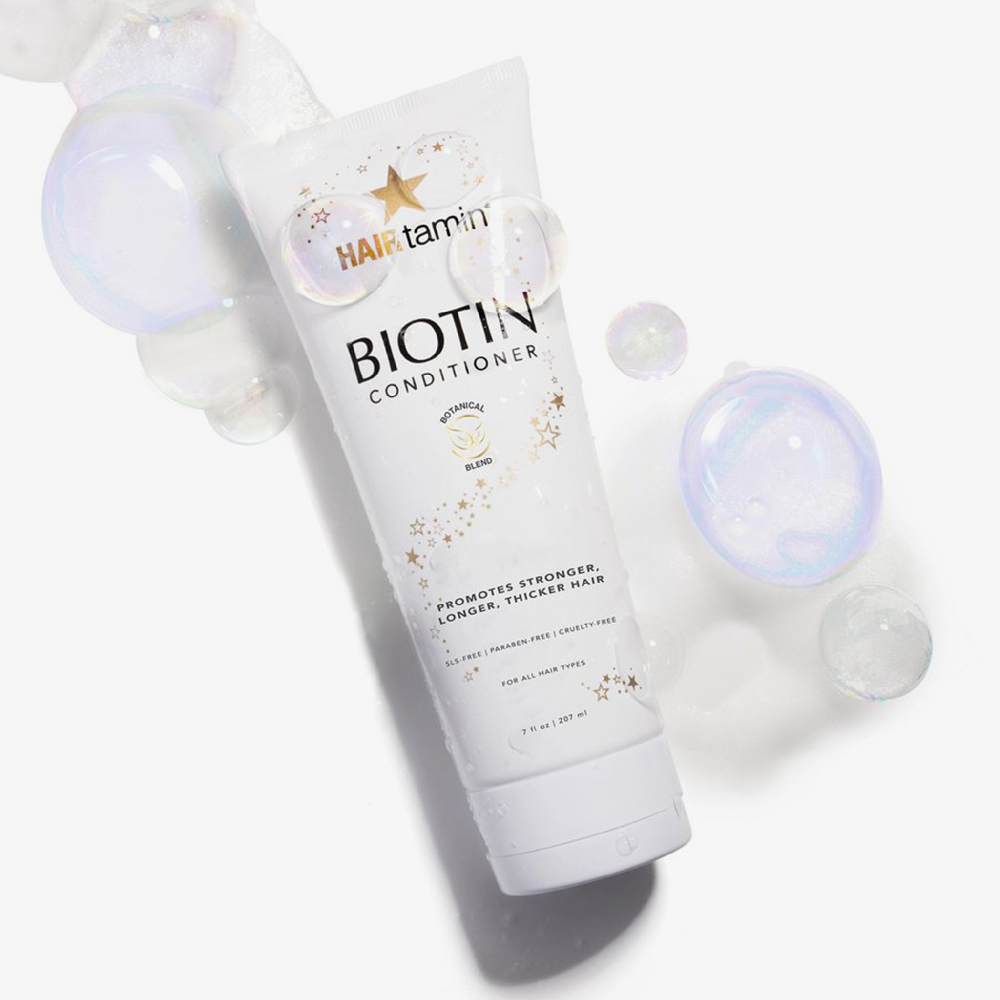 Tube blanc "HAIRtamin Biotin Conditioner" avec bulles de savon. "Botanical Blend". Pour tous types de cheveux. 207 ml.