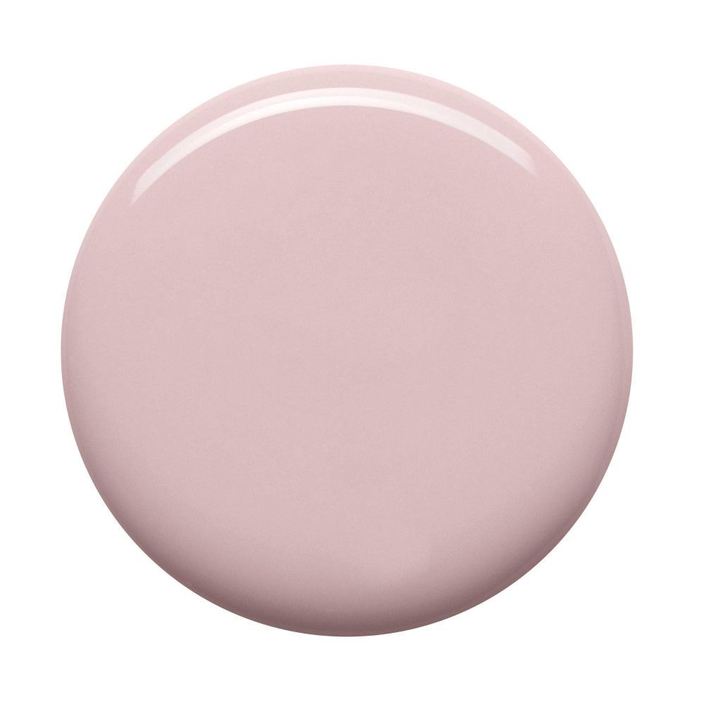 Tache ronde de vernis à ongles rose clair.