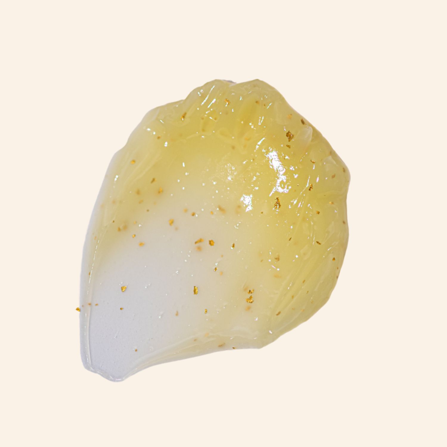 Gelachtige substantie met gouden deeltjes. Tekst: Ascorbinezuur, Squalane, Arginine, Glutathion, Cafeïne.