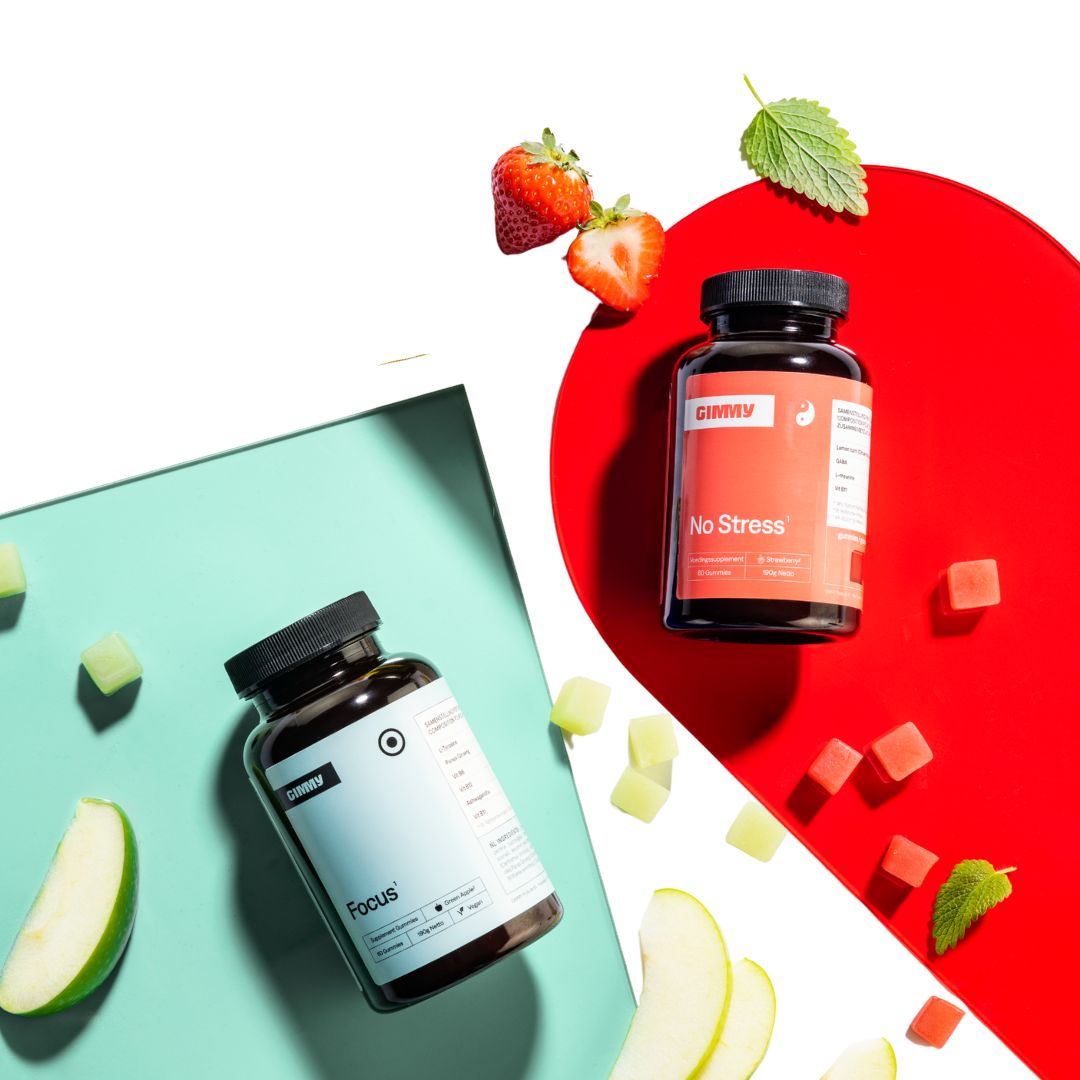 Twee GIMMY-flessen. Rode en groene gummies, aardbeien, appelschijfjes en munt.