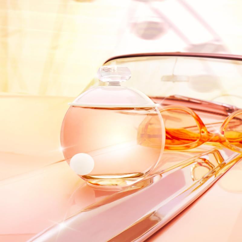 Flacon rond en verre avec bouchon, lunettes de soleil. Le flacon contient une bille blanche à l'intérieur.