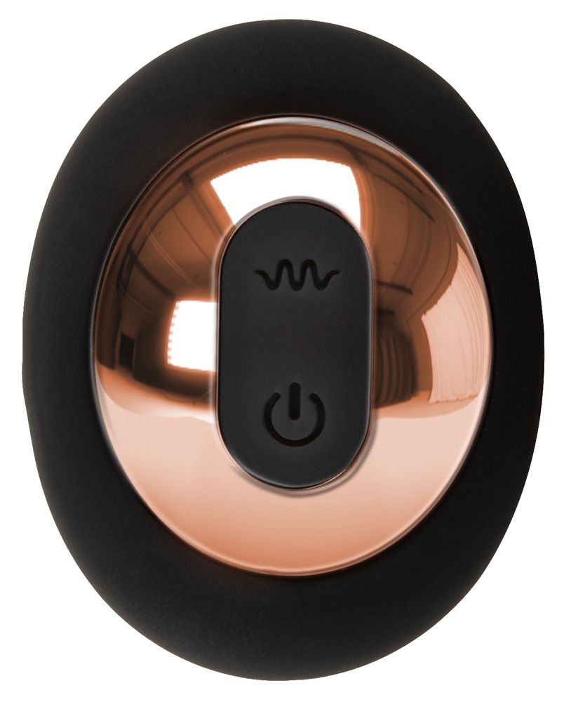 Plug anal noir à structure rainurée en spirale, tenu dans une main.