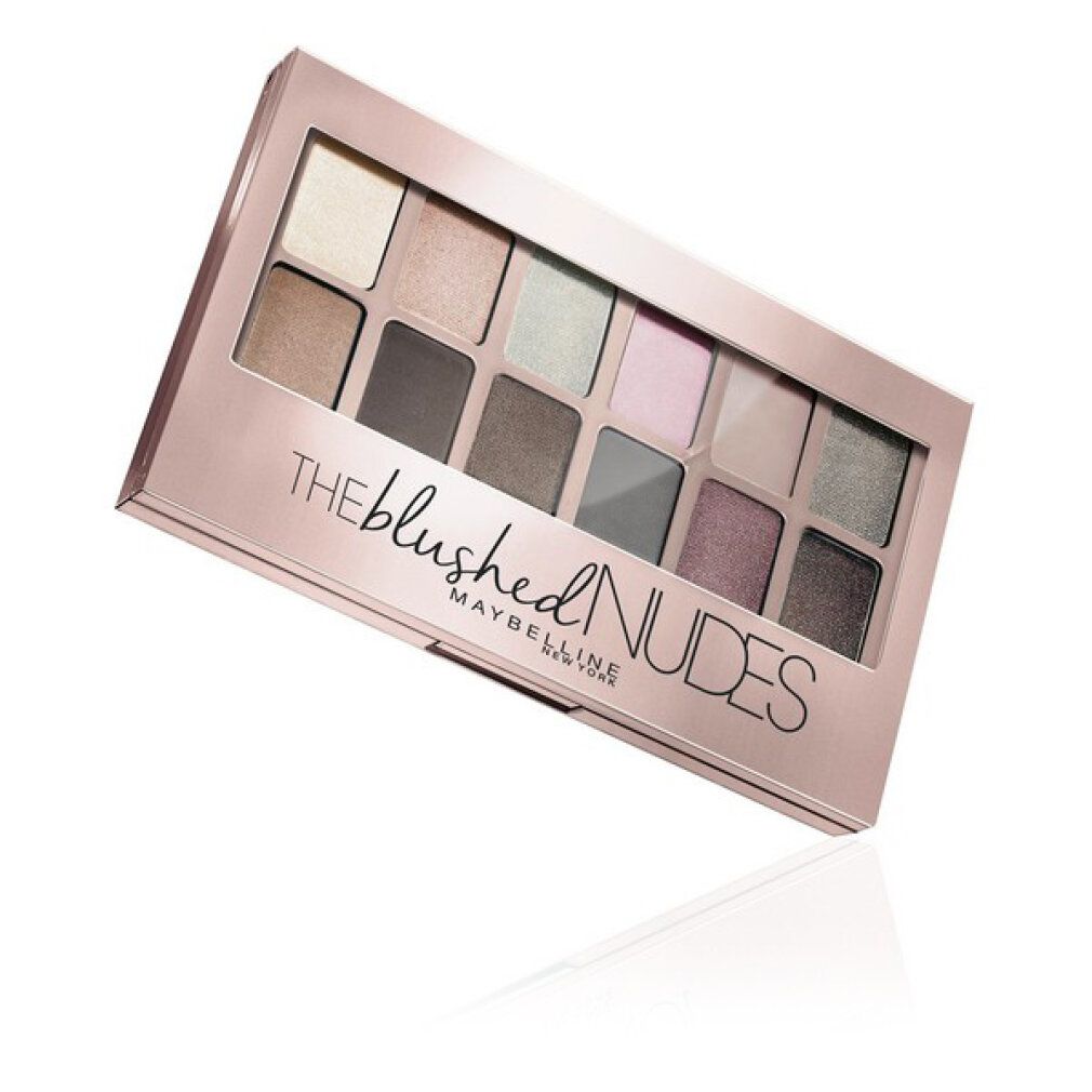 Palette de fards à paupières avec 12 teintes. Emballage rose doré. Inscription : THE blushed NUDES, MAYBELLINE NEW YORK.