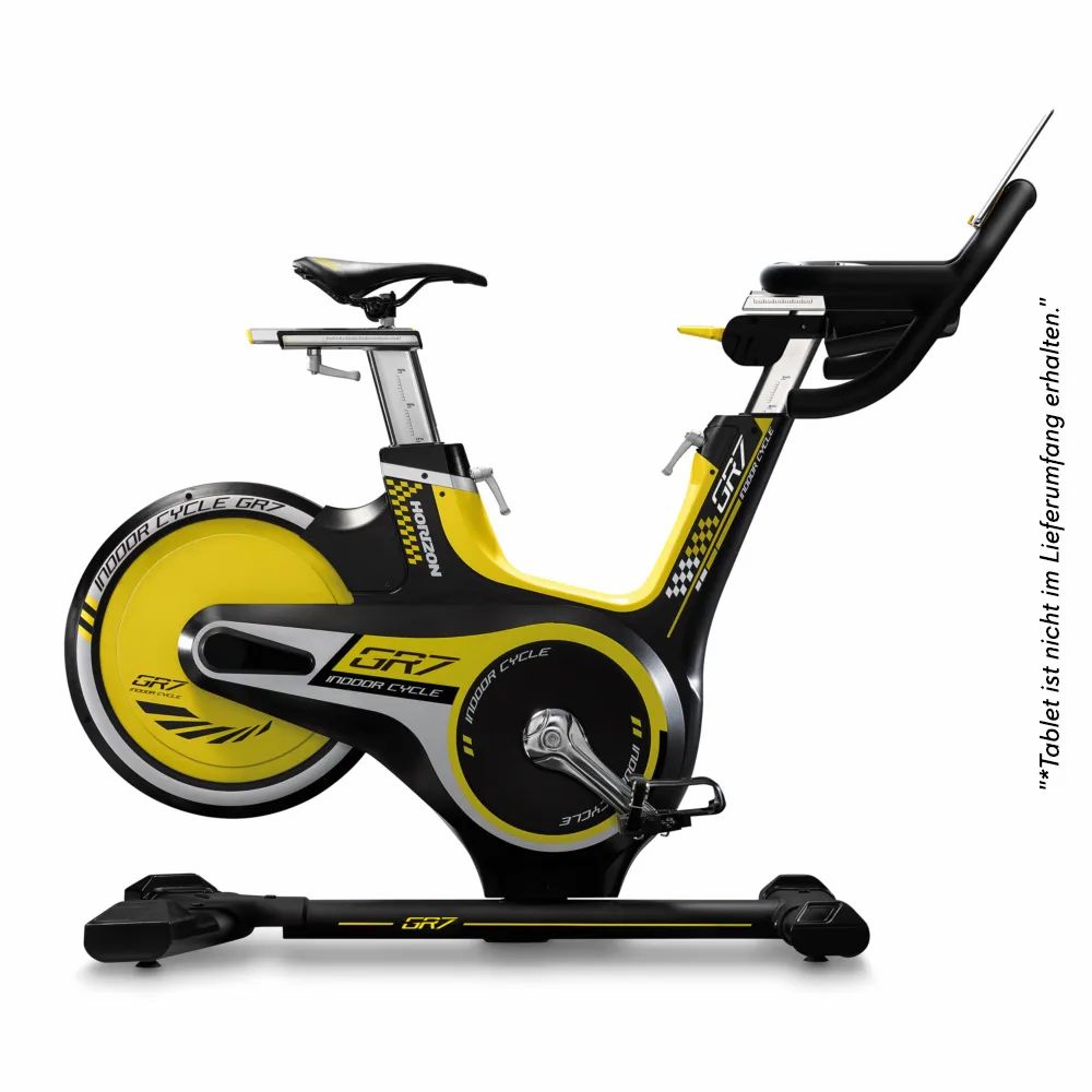 Vélo d'intérieur noir et jaune. Selle, guidon, pédales et volant d'inertie visibles. Inscription: GR7.