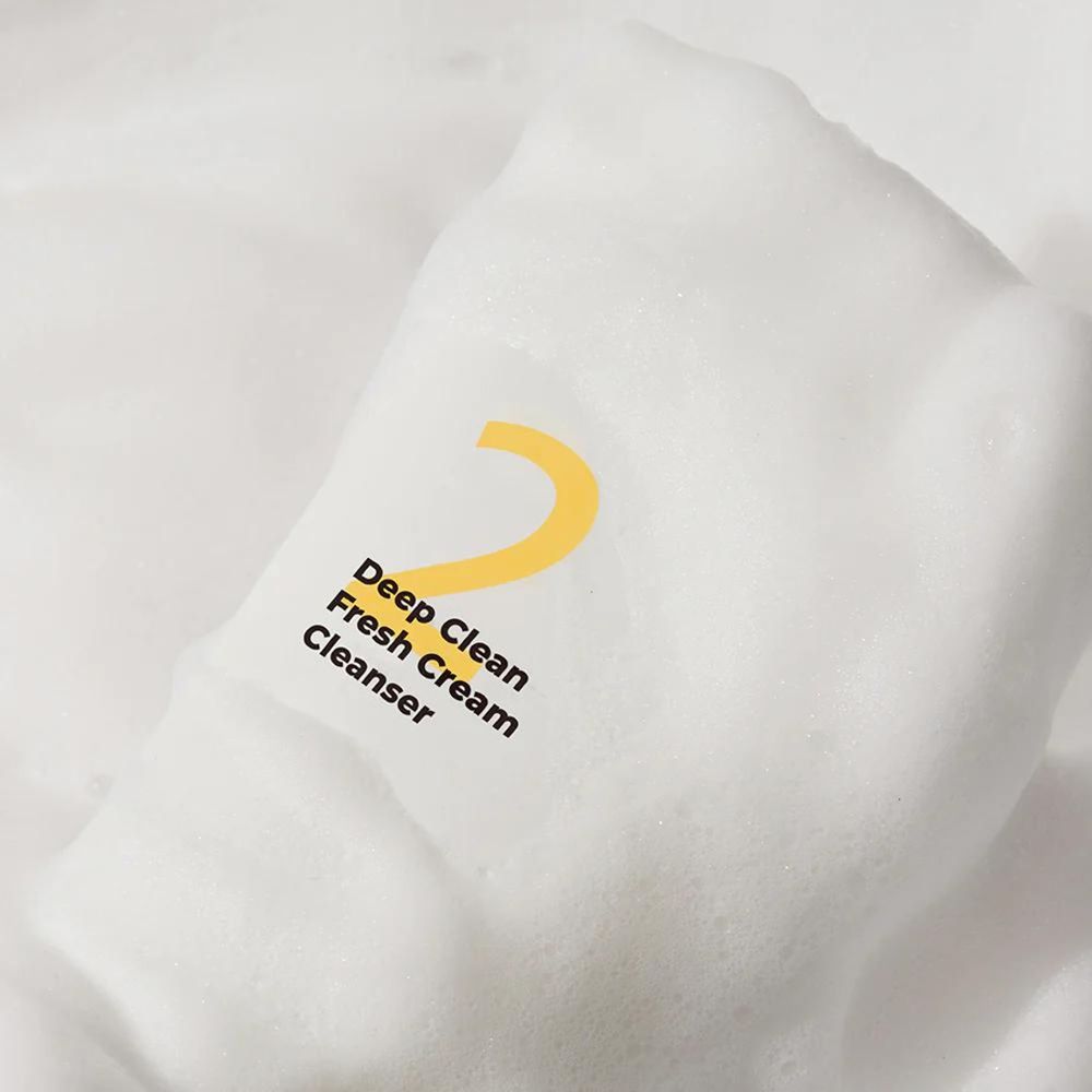 Schuim met gele "2" en tekst "Deep Clean Fresh Cream Cleanser".