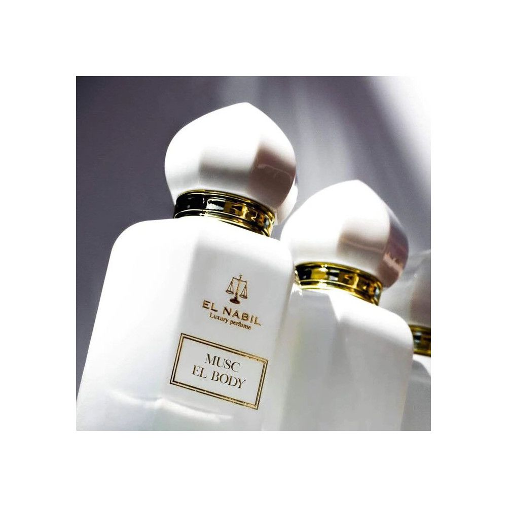 Flacon de parfum blanc, détails dorés. Inscription: Musk El Body. Marque: El Nabil.