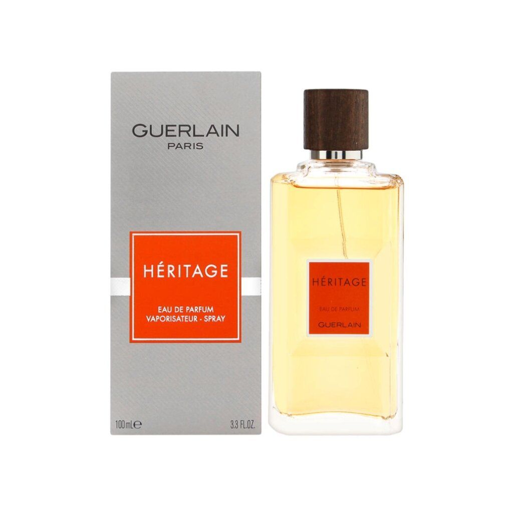 Parfumfles naast verpakking. Fles met bruine dop, oranje label. Guerlain Héritage.