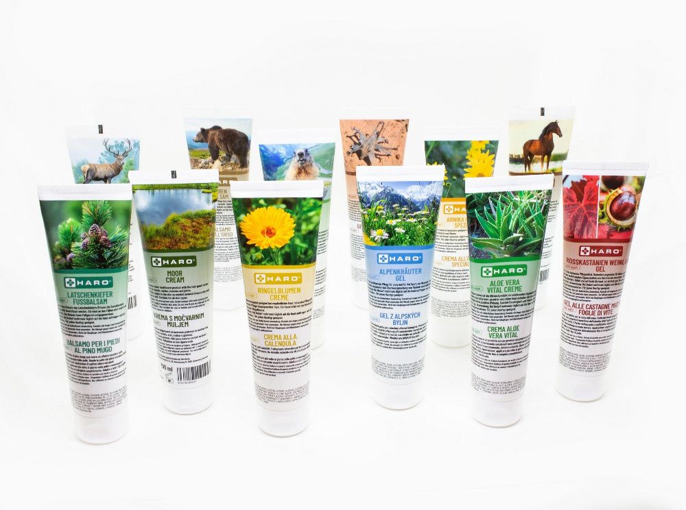Meerdere crèmetubes met verschillende afbeeldingen en namen. Haro-logo op elke tube. Witte achtergrond.
