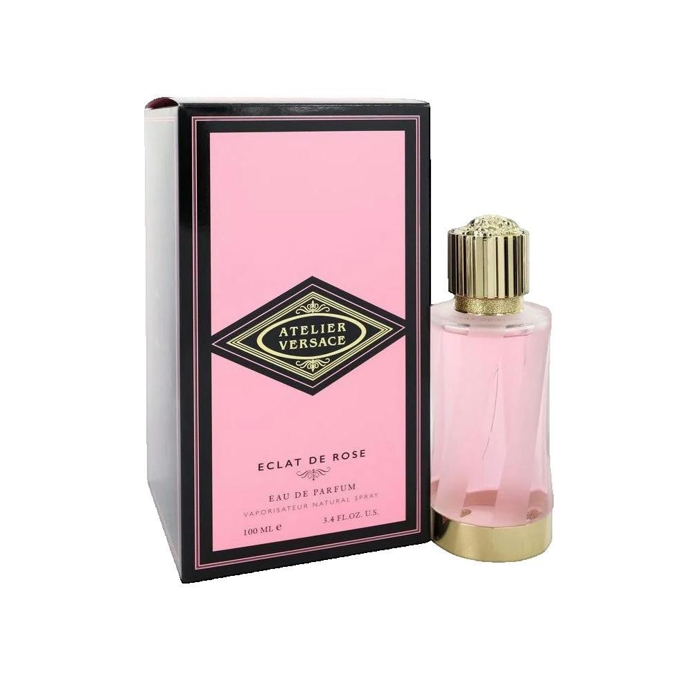 Roze parfumfles en verpakking. Zwarte lijst, roze achtergrond. Gouden dop. Opschrift: Atelier Versace, Éclat de Rose.
