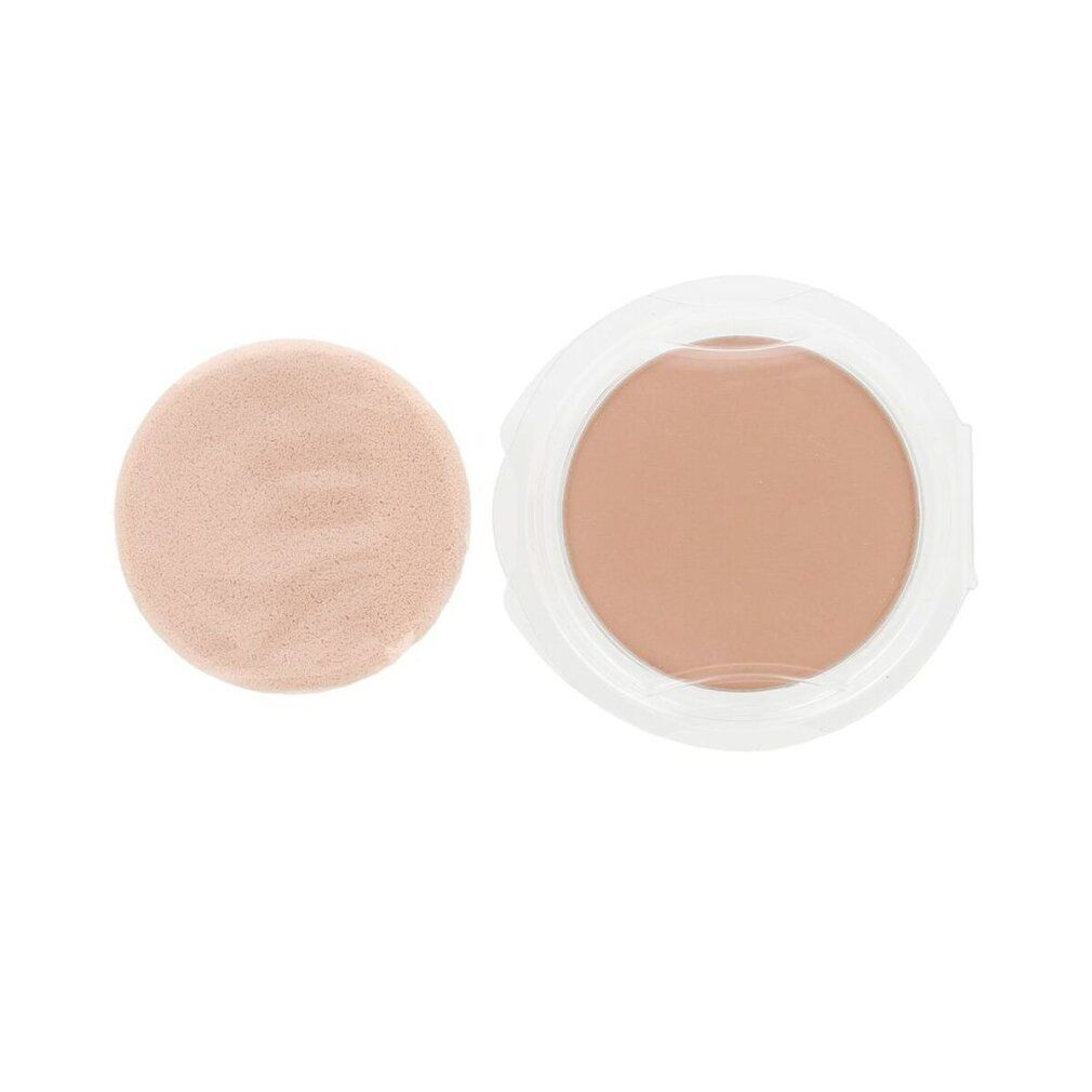 Poudre compacte beige dans un contenant blanc. À côté, un applicateur rond beige.
