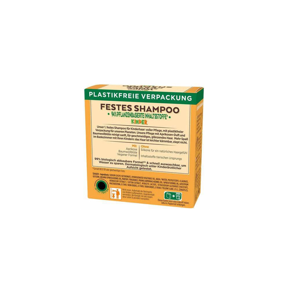 Shampoo solide pour enfants, emballage sans plastique. Inscription : 94% d'ingrédients végétaux. Emballage jaune-orange.