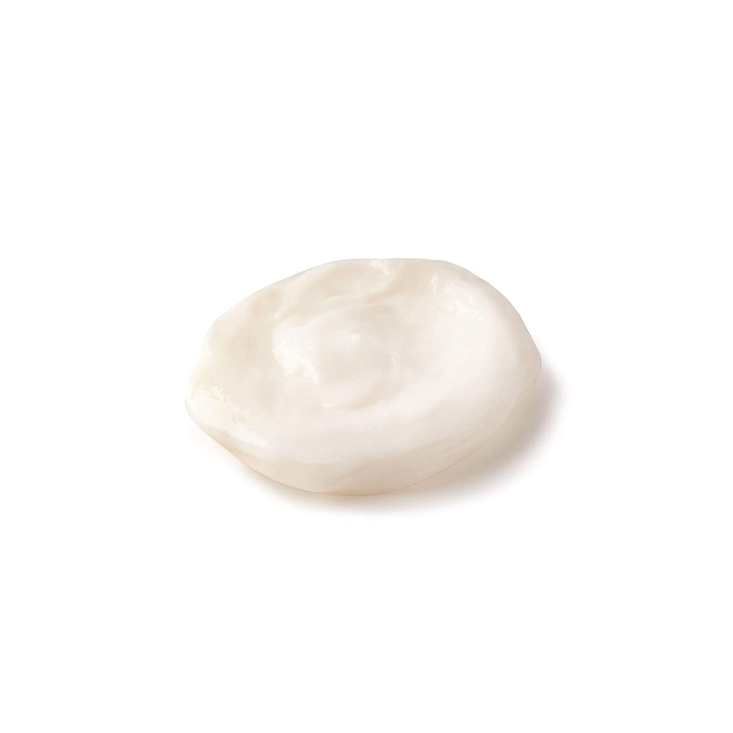 Klodder witte crème op witte achtergrond. Textuur zichtbaar.