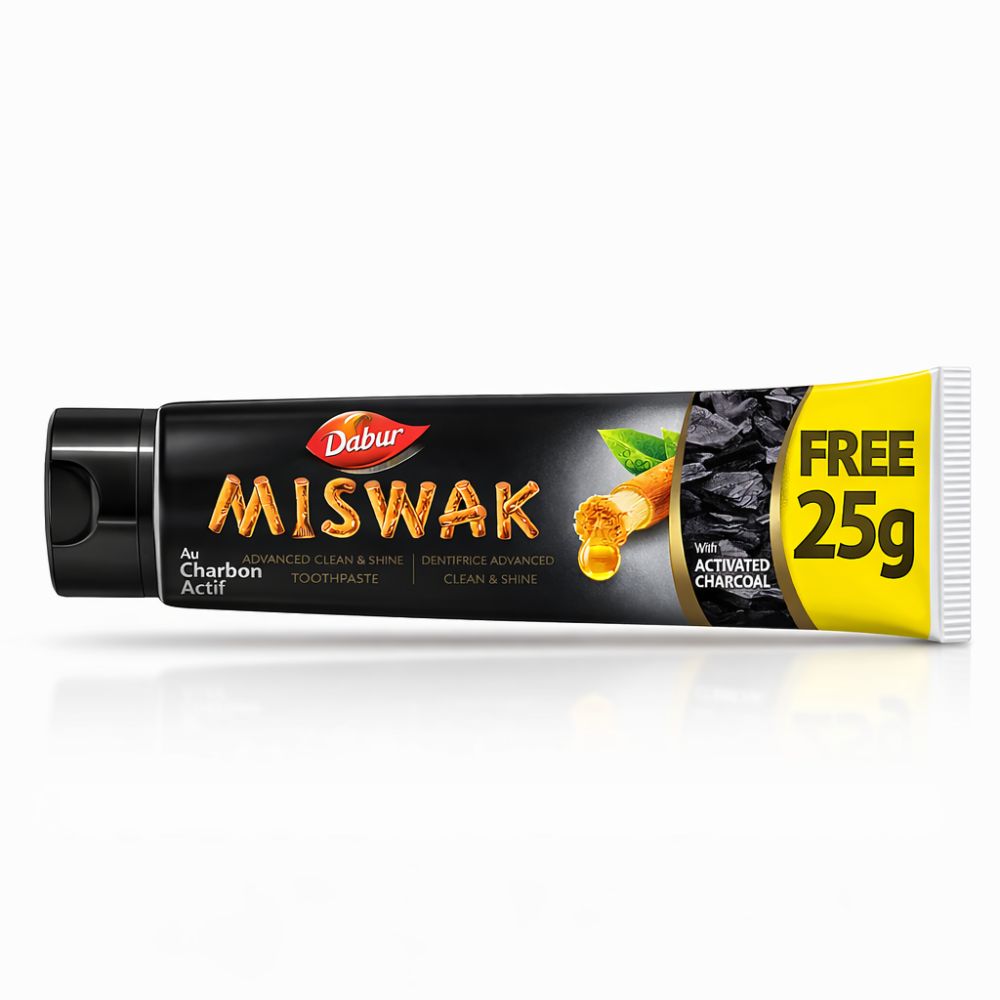 Dabur Miswak Dentifrice au Charbon Actif, 25g gratuit. Tube noir avec accent jaune.