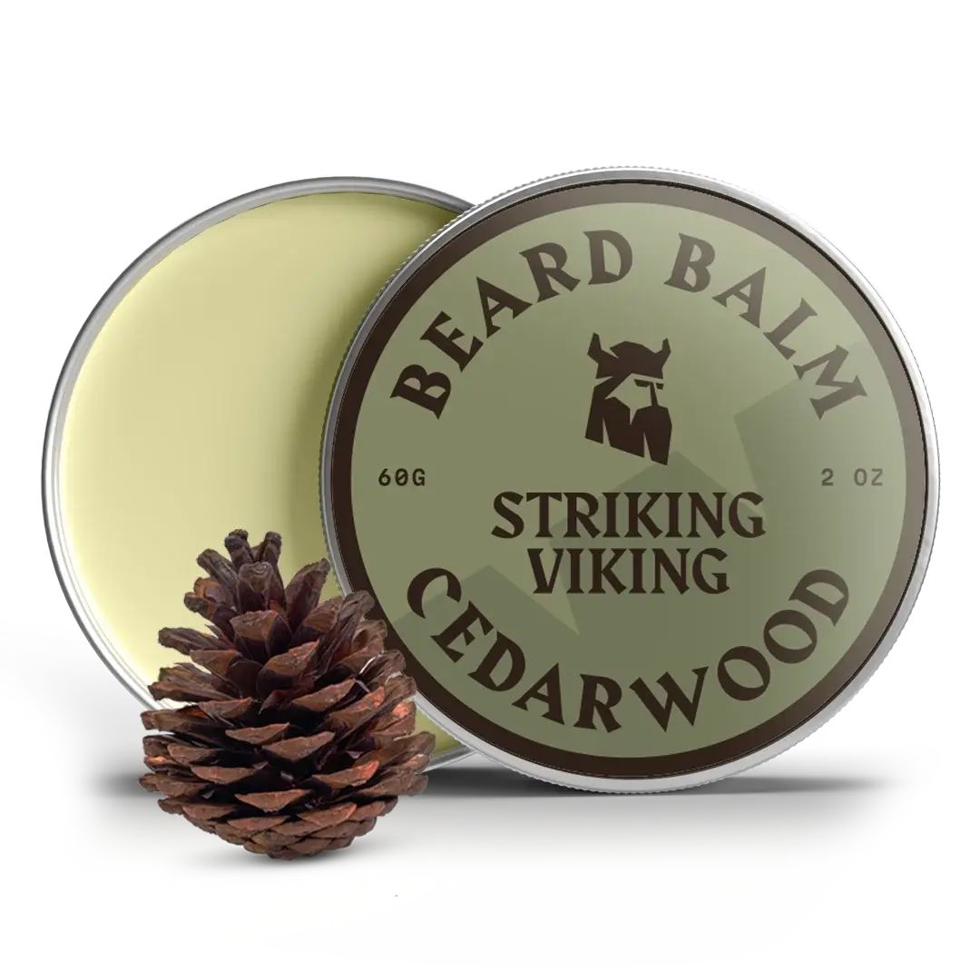 Boîte ronde de baume à barbe ouverte. Couvercle avec texte et logo. À côté, une pomme de pin.