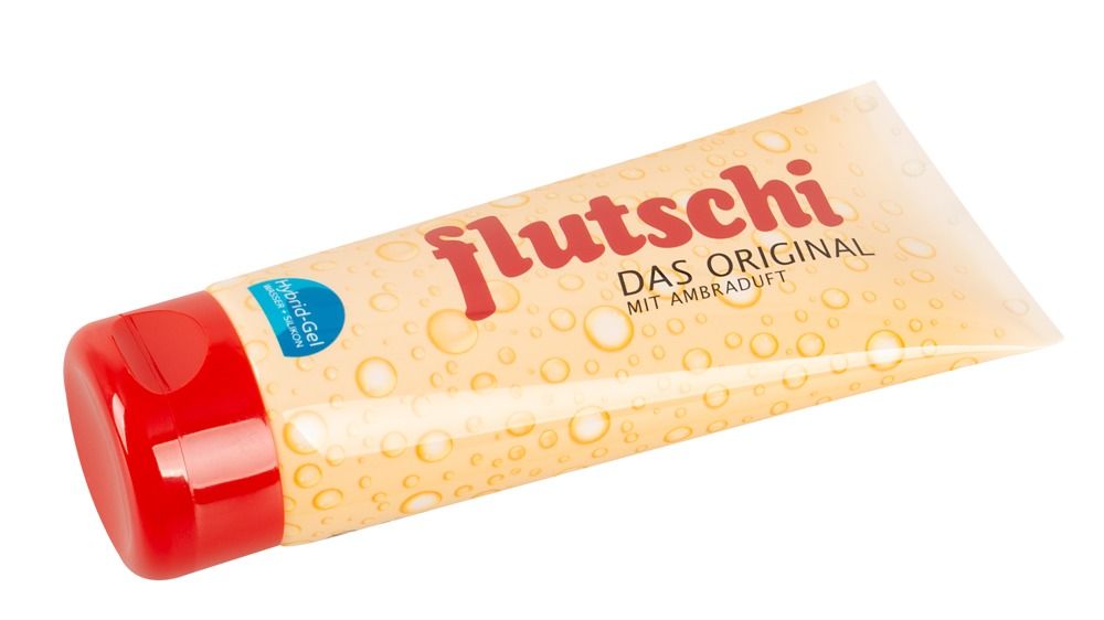 Tube avec bouchon rouge. Inscription: flutschi, DAS ORIGINAL, MIT AMBRADUFT. Tube beige-jaune avec motif bulles.