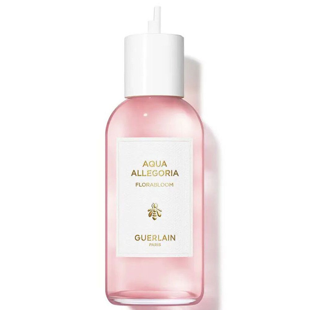 Flacon rose avec bouchon blanc. Étiquette: Aqua Allegoria Florabloom, abeille, Guerlain Paris.