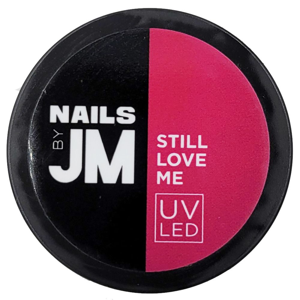 Récipient rond noir et rose. Inscriptions: NAILS BY JM, STILL LOVE ME, UV LED.