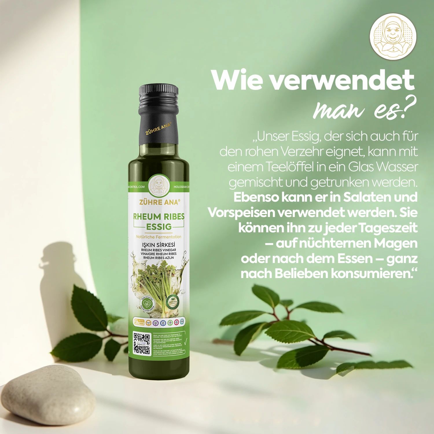 Fles Zühre Ana Rheum Ribes Essig naast groene bladeren en een steen. Tekst in het Duits: "Hoe gebruik je het?"