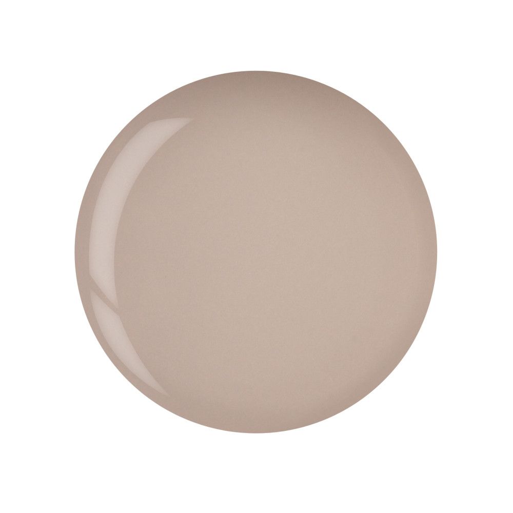 Tache circulaire de vernis à ongles beige clair. Surface brillante.