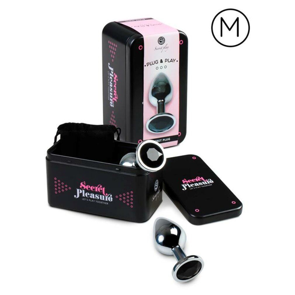 Plug anal en métal avec une large base et des ornements de pierres noires. Boîte de rangement et pochette incluses. Taille M.