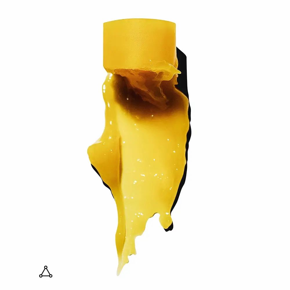 Substance jaune s'écoulant d'un objet cylindrique. Fond noir. Symbole triangulaire en bas à gauche.