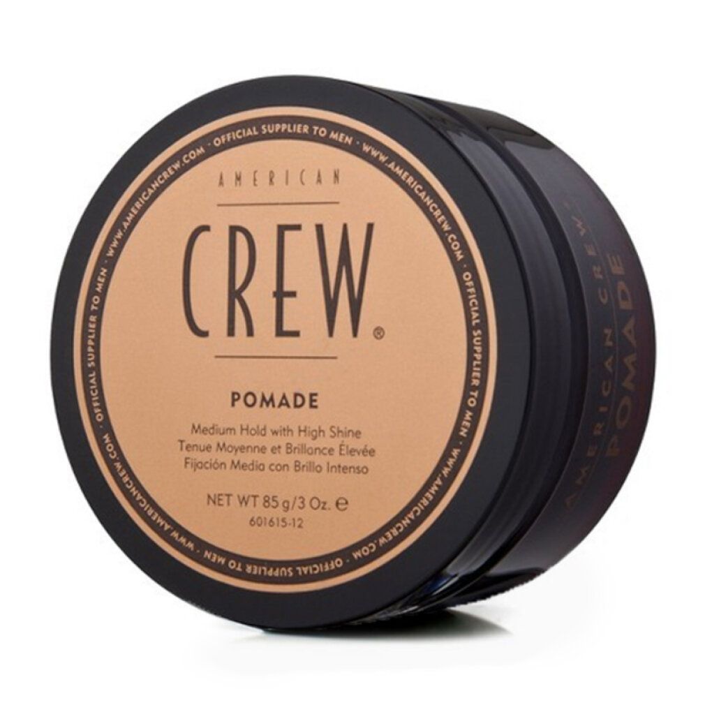 Ronde zwarte pot met bruin deksel. Opschrift: AMERICAN CREW. Pomade. Netto 85 g/3 Oz.