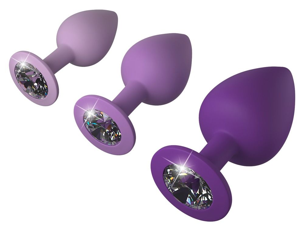 Trois plugs anaux violets avec ornements en cristal, tailles variées.
