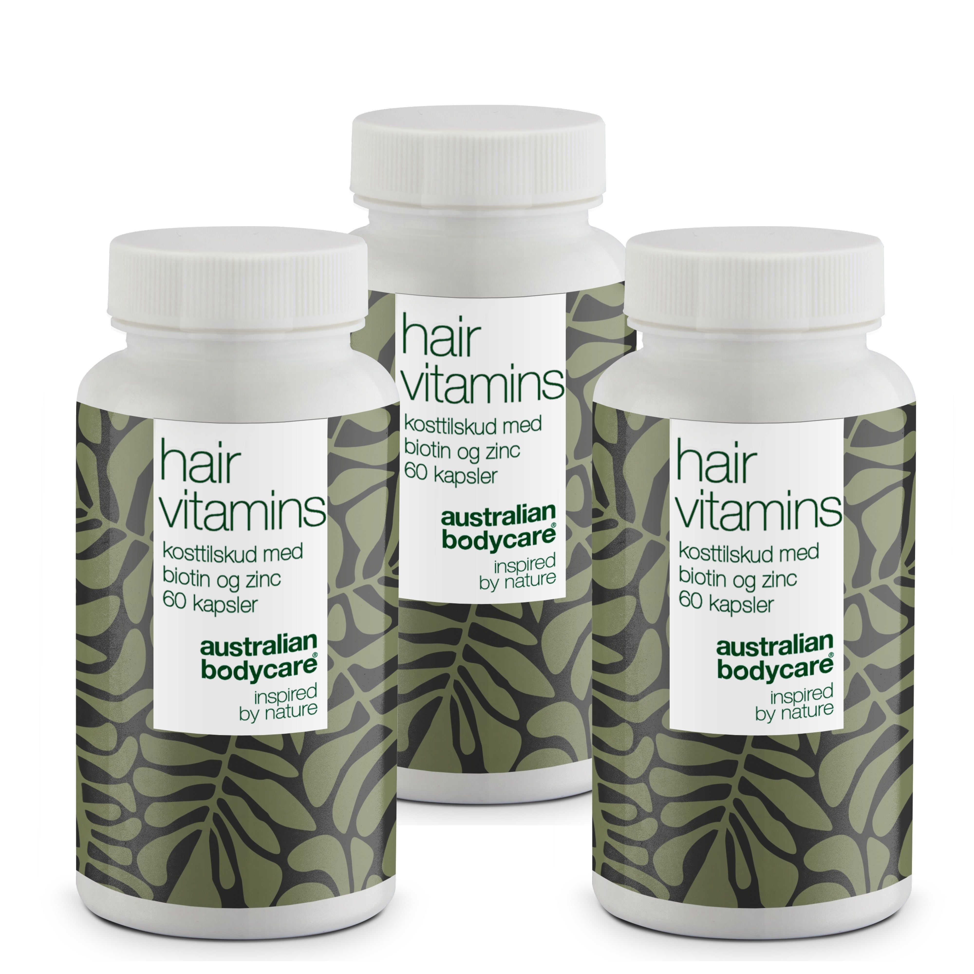 Drie witte flessen met etiketten. Opschrift: Hair Vitamins, biotine en zink, 60 capsules. Merk: Australian Bodycare.