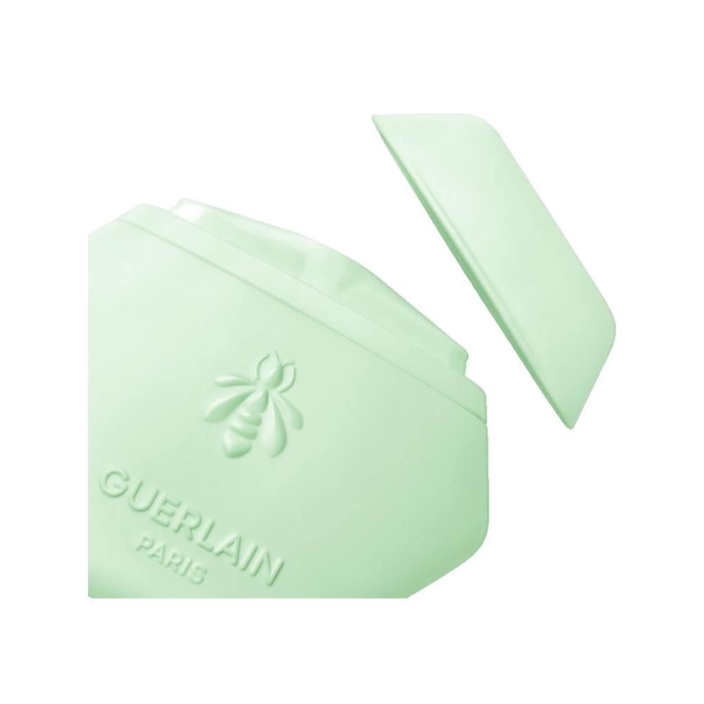 Contenant vert clair ouvert avec abeille en relief et inscription Guerlain Paris.
