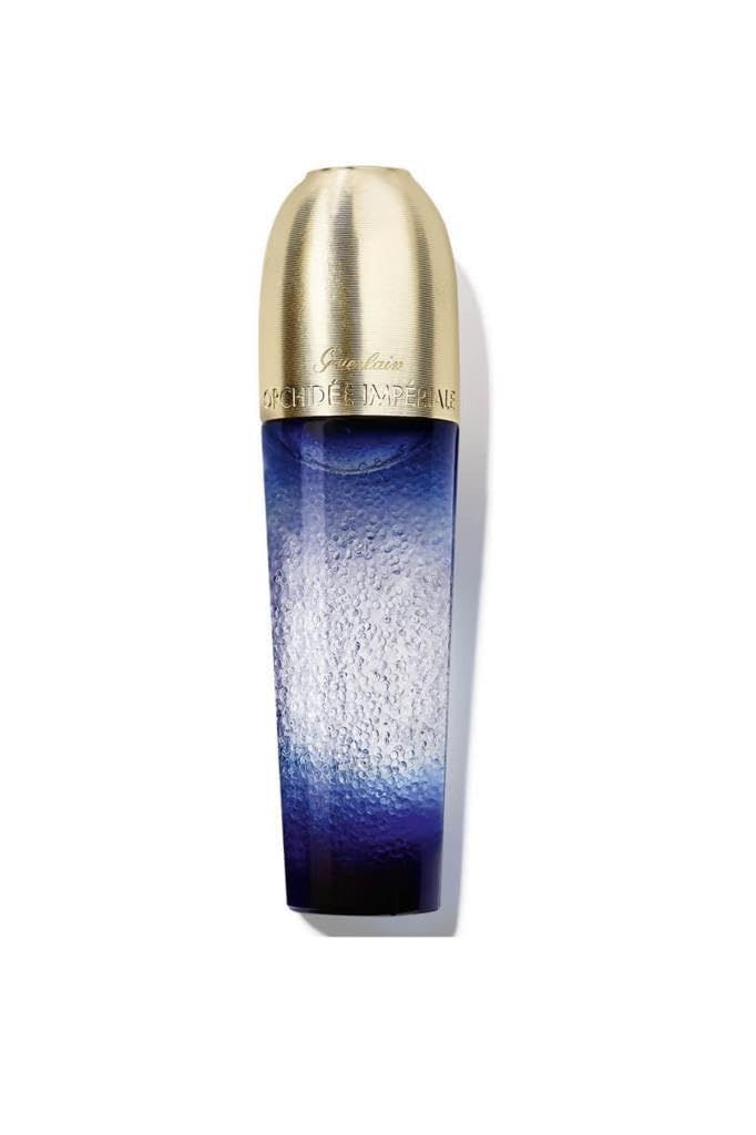 Blauwe transparante fles met gouden dop. Opschrift: Guerlain Orchidée Impériale. Verticale weergave.