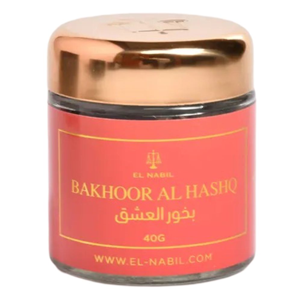 Pot en verre avec couvercle doré. Étiquette rouge avec texte: Bakhoor Al Hashq, marque El Nabil, 40g.