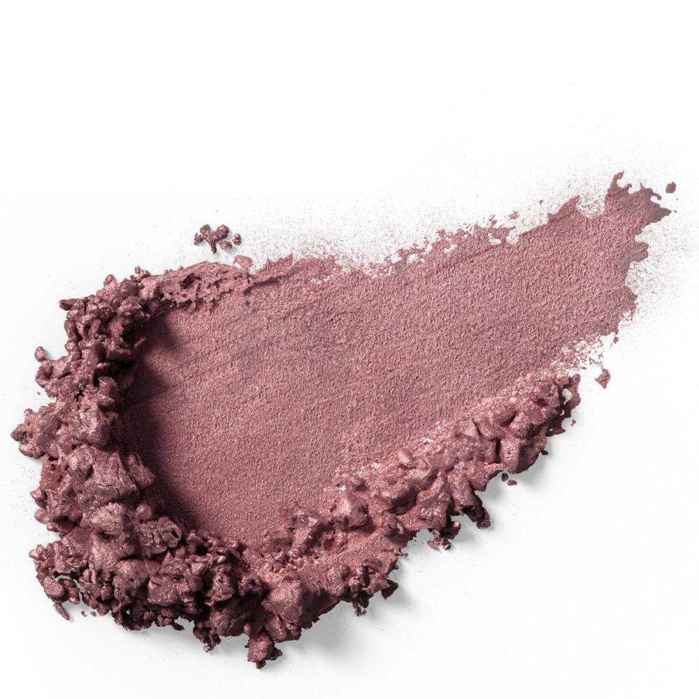 Roze oogschaduwveeg op witte achtergrond. De textuur is poederachtig en onregelmatig.