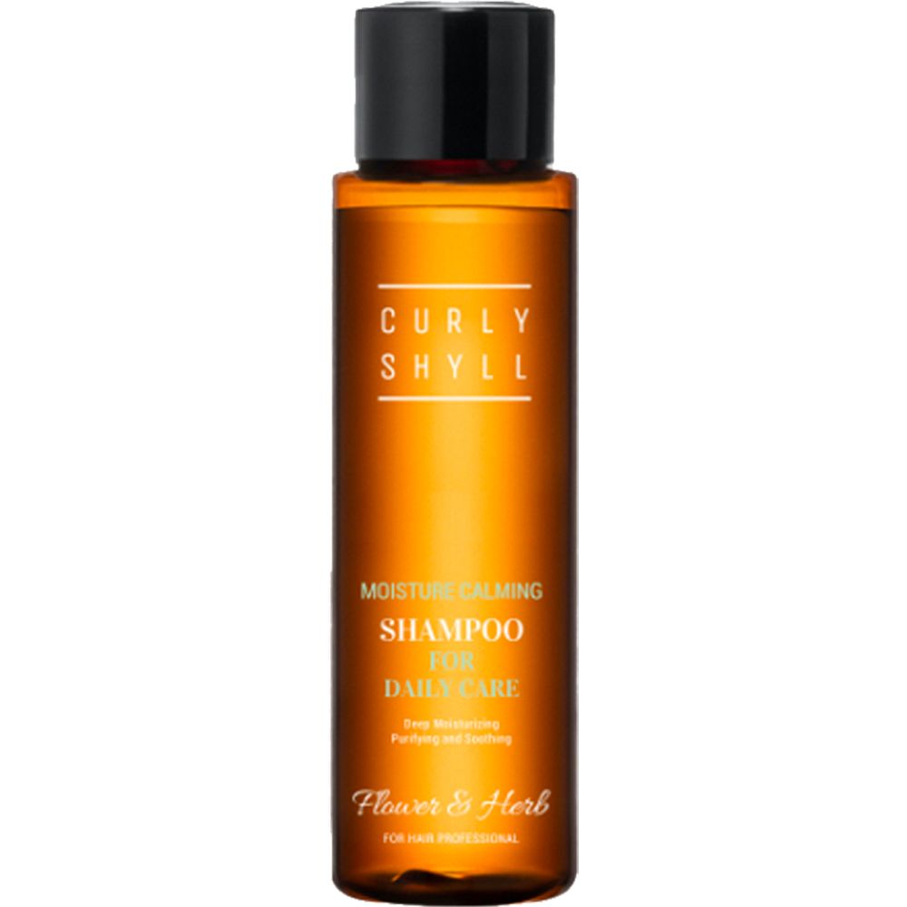Bruine shampoo fles met zwarte dop. Opschrift: CURLY SHYLL, Moisture Calming Shampoo, Flower & Herb.