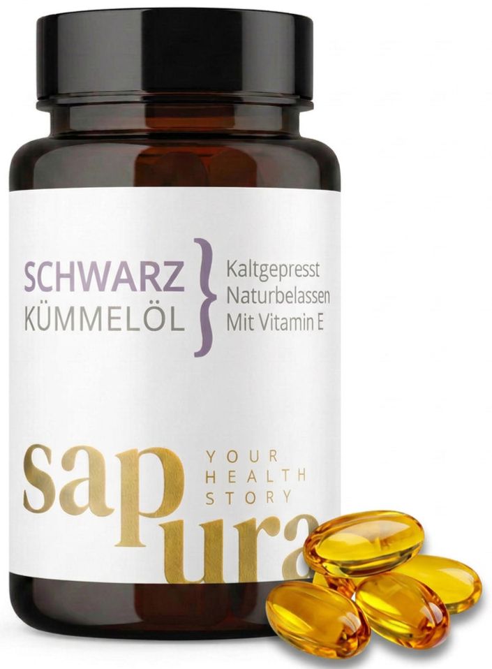 Flacon en verre brun avec capsules d'huile de nigelle, pressée à froid, naturelle, à la vitamine E. Logo Sapura visible.