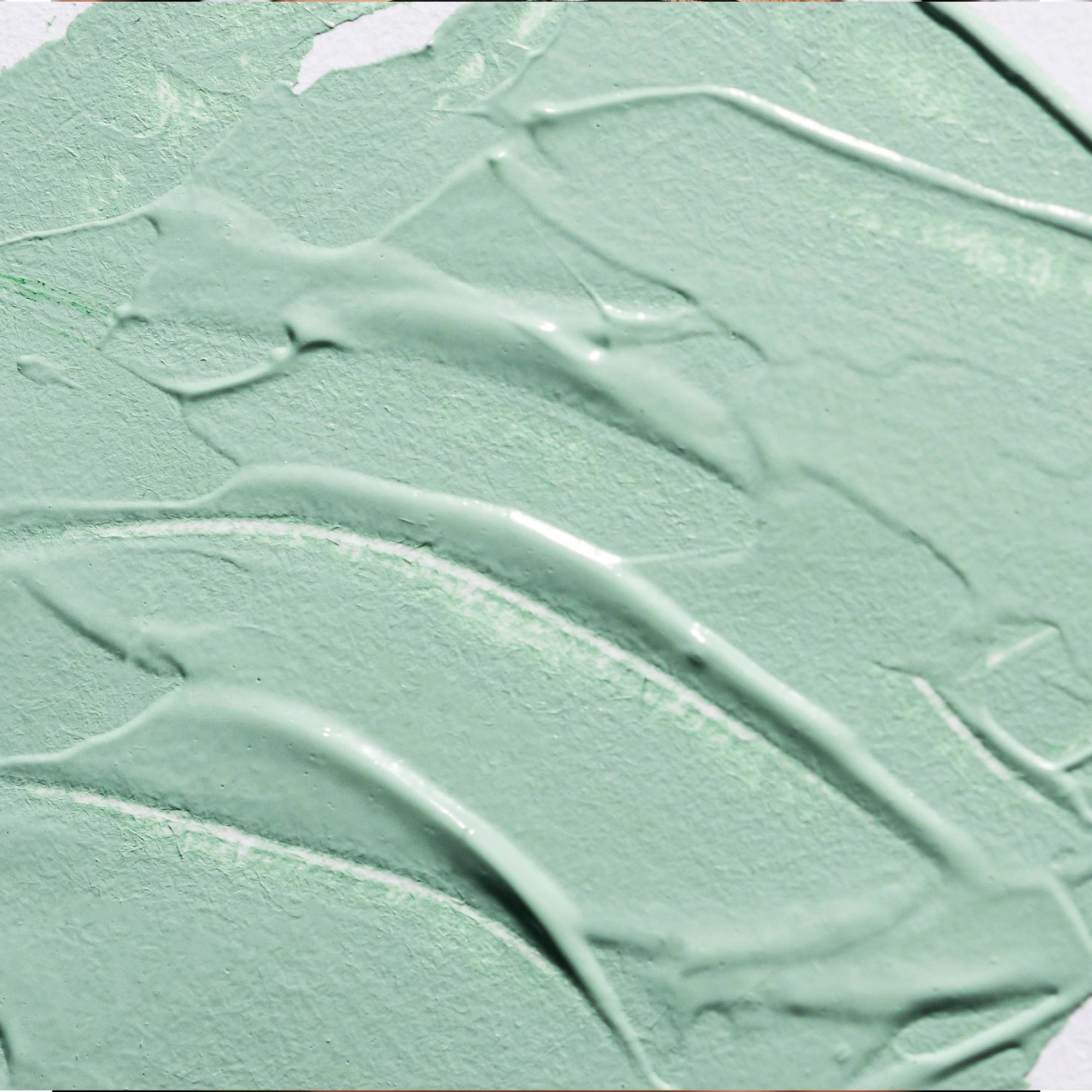 Close-up van groen kleimasker. Textuur met sporen van gebruik.