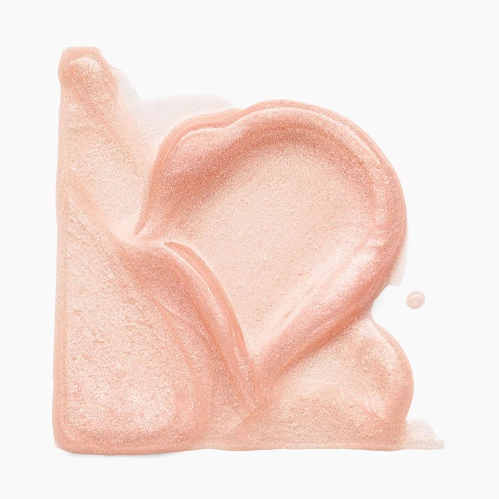 Uitgesmeerde lipgloss in roze-parelmoer textuur. Vorm van een hart.