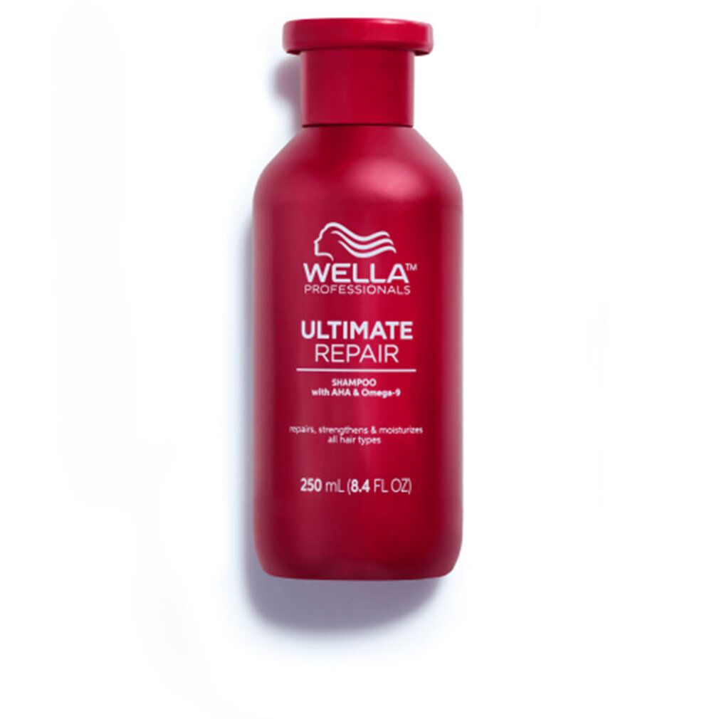 Rode shampoo fles met wit logo en tekst 'Ultimate Repair'. Tekst: 'Shampoo met AHA & Omega-9'. Op witte achtergrond.